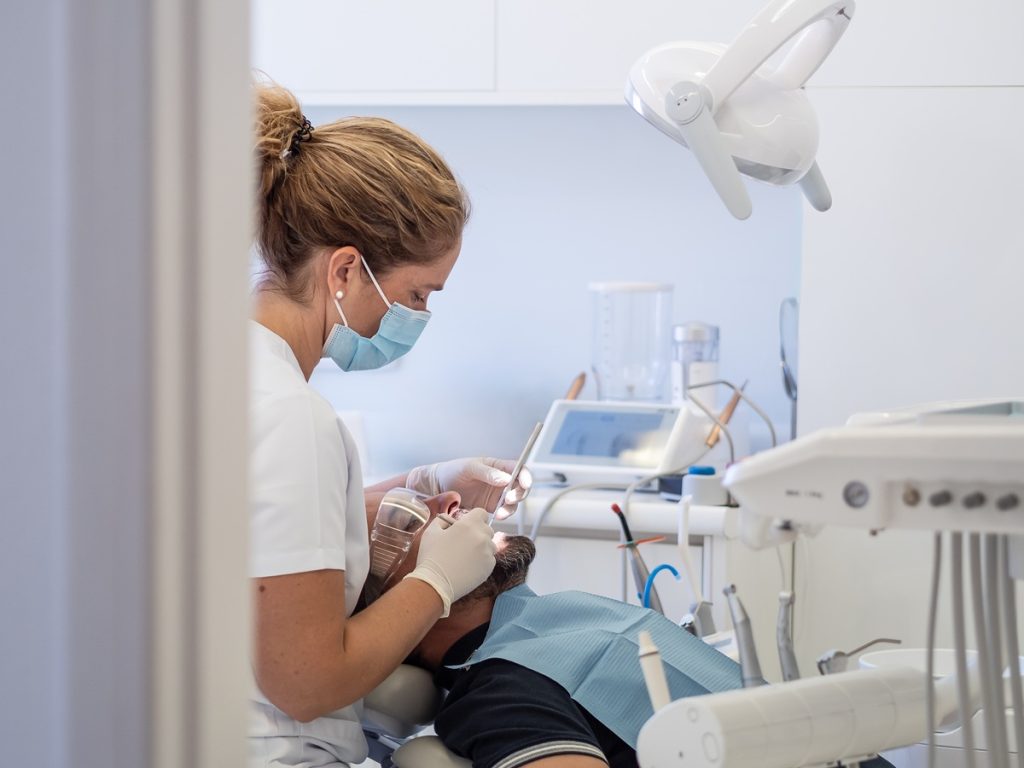 Dental hygienist performing professional teeth cleaning in Brampton dental clinic